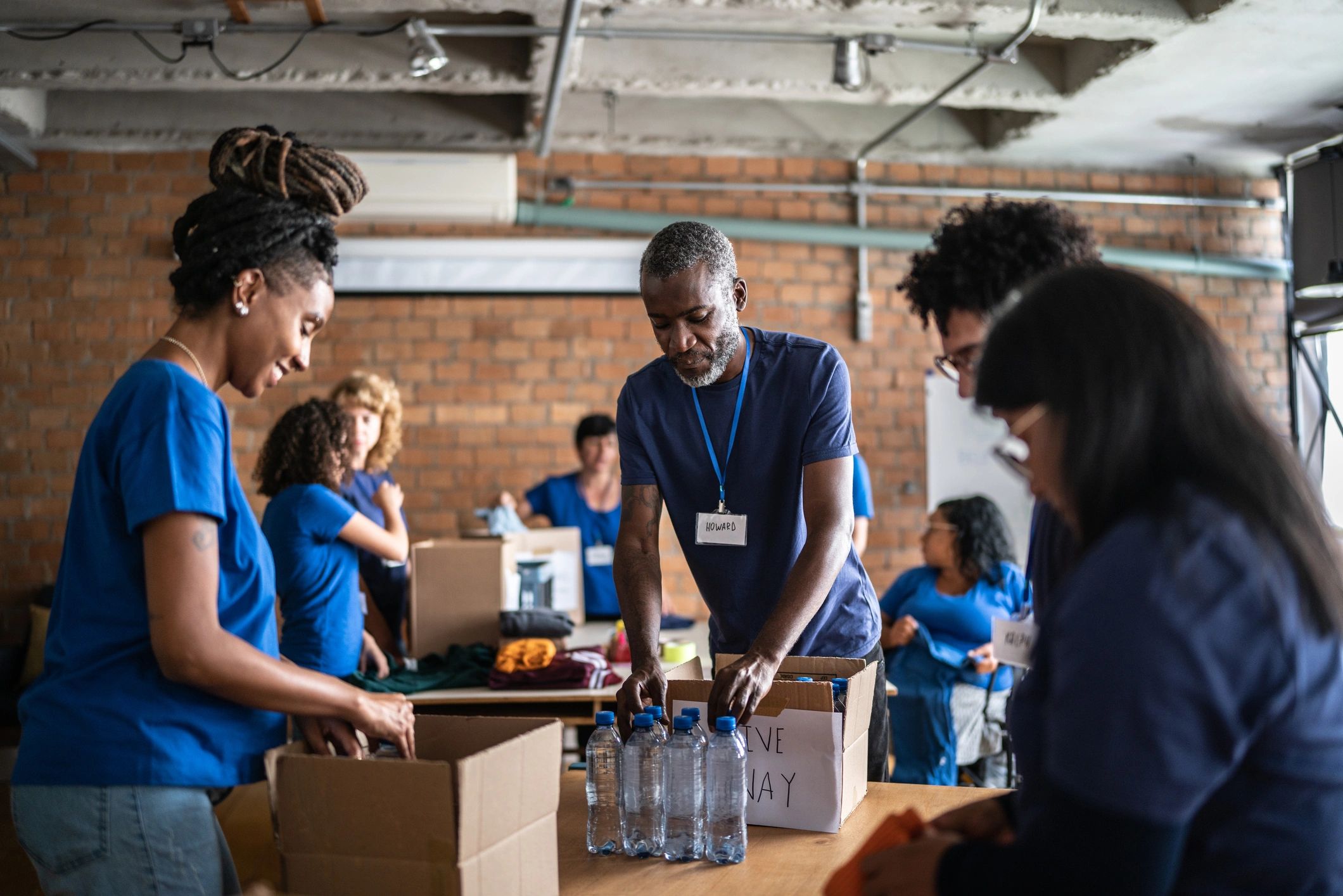 Volunteers organizing donated items at a community center